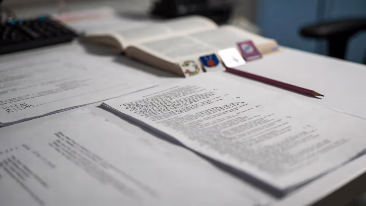 Legal research desk with an open casebook, blurred citations, and tabs for landmark cases