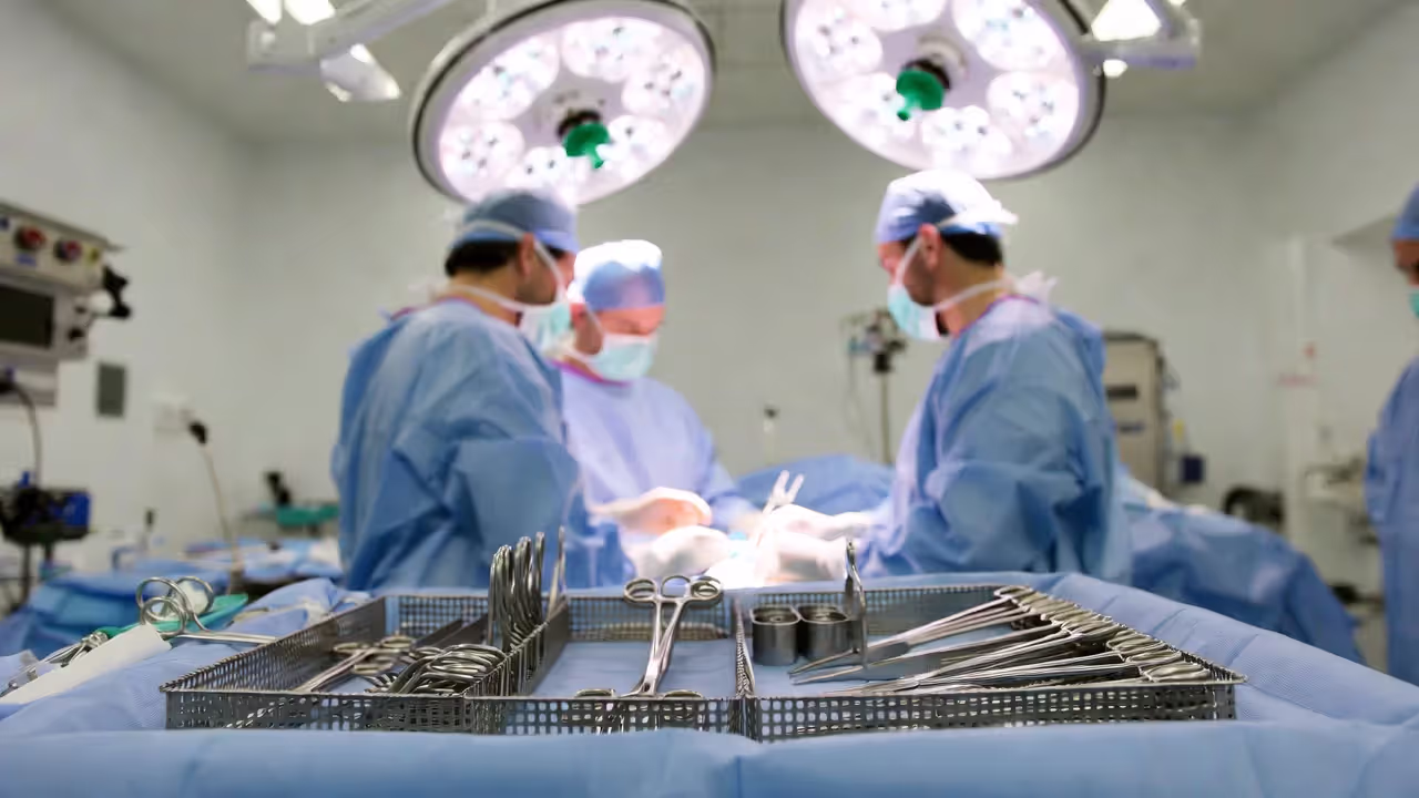 Operating room setup with surgical instruments prepared on sterile field